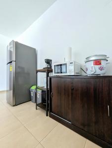 a kitchen with a counter with a microwave and a refrigerator at Yc l Habitacion av Balboa - GB701-B in Panama City