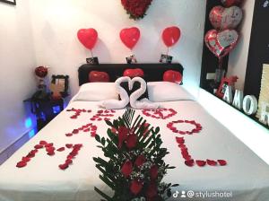 una cama con dos corazones y dos cisnes en ella en Stylus Hotel, en Iquitos