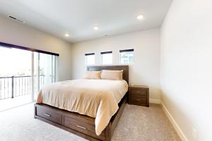a bedroom with a bed and a large window at Purple Flower in Park City