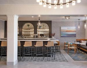 a lobby with a bar and chairs and a couch at Hotel Virginia Santa Barbara, Tapestry Collection by Hilton in Santa Barbara