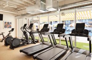 a gym with several treadmills and exercise bikes at Avatar Hotel Santa Clara, Tapestry Collection by Hilton in Santa Clara