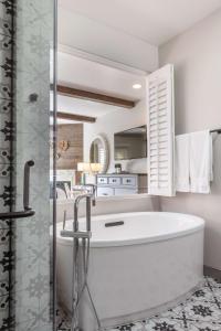 a white bathroom with a tub and a shower at The Lodge at Healdsburg, Tapestry Collection by Hilton in Healdsburg