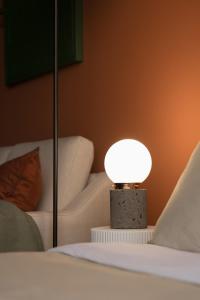 una lámpara sentada en una mesa junto a una cama en Casa Terra, Inspirador y Magico Loft en Ciudad de México