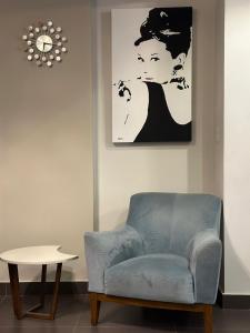 a living room with a blue chair and a table at Mirage residence resort in Cairo