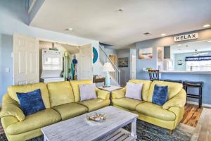 a living room with a yellow couch and a table at Bethany Bay - 37434 Pettinaro Dr #4805 in Ocean View