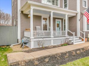 a house with an american flag on the front porch at Essex, MA Modern Historic close to Salem in Essex