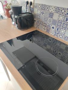 a kitchen with a sink with a laptop in it at Chabili Appartements in Temara