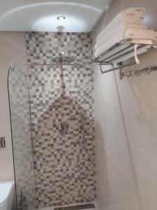 a shower in a bathroom with a glass shower at Chabili Appartements in Temara