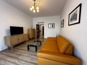 a living room with a couch and a flat screen tv at Apartment Karla Capka Street in Karlovy Vary