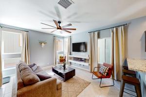 a living room with a couch and a ceiling fan at The Pines in Flagstaff