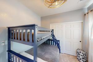 a blue bunk bed in a room with a chandelier at The Pines in Flagstaff