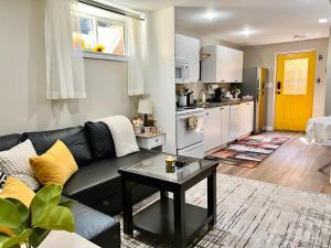 a living room with a couch and a table at Yellow Door Suite in Campbell River