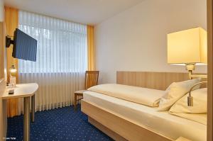 En eller flere senger på et rom på Hotel BonaMari