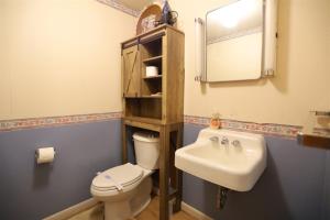 a bathroom with a sink and a toilet and a mirror at Beechwood 3, Lincoln, New Hampshire in Lincoln