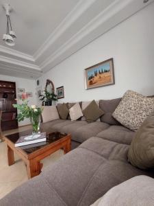 a living room with a couch and a coffee table at Chabili Appartements in Temara