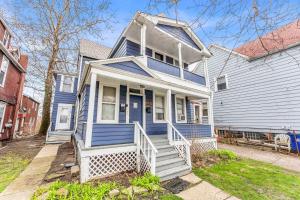 a blue house with a blue door on a street at Historic Cozy Haven in Little Italy in Cleveland