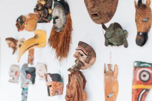 a group of masks hanging on a wall at Casa Del Calvario, 3BR Villa in Antigua Guatemala in Antigua Guatemala