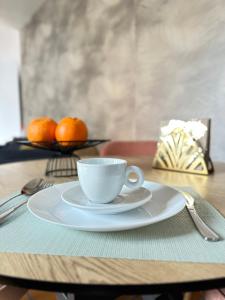 a cup of coffee on a table with oranges at Cozy Up Spain in Valencia +22 photos
