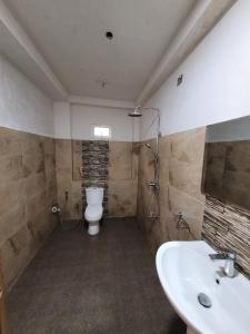 a bathroom with a toilet and a sink at Catch The Ella Train Hostel in Kandy