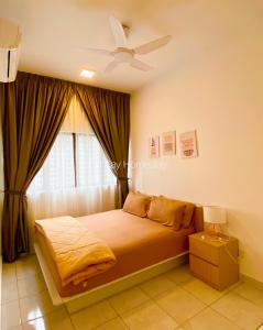 a bedroom with a bed with a ceiling fan and a window at Youth City 2 Bedroom Pool View by DKAY in Nilai in Nilai
