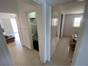 a living room with a hallway with a mirror and a bathroom at Apartmani ARIANA in Dobra Voda +53 photos