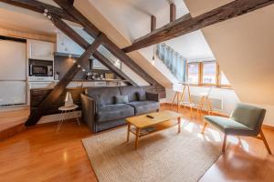 a living room with a couch and a table at LE PAQUIER T3 - à deux pas du lac in Annecy