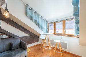 a living room with a couch and a table at LE PAQUIER T3 - à deux pas du lac in Annecy
