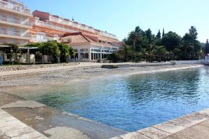a pool of water in front of a building at Seaside house for families with children Cavtat, Dubrovnik - 22828 in Cavtat +10 photos