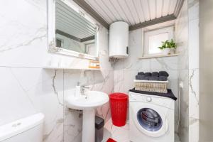 a bathroom with a washing machine and a sink at Seaside house for families with children Cavtat, Dubrovnik - 22828 in Cavtat