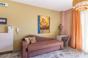 a living room with a couch and a table at Fantasia double apartments by the sea Rethymno in Rethymno Town +44 photos