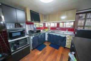 a kitchen with a sink and a stove top oven at 貸切民泊勝山ベース325 福井県立恐竜博物館まで車で5分 