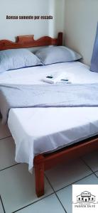 Ein Bett oder Betten in einem Zimmer der Unterkunft Pousada Parada Da Fé