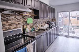 a kitchen with a sink and a counter top at Beautiful room with private powder room in Vaughan