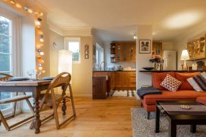 a living room with a table and a couch at Quiet & calm apartment with garden in Brighton & Hove