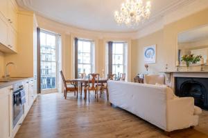 a living room with a white couch and a table at Contemporary Regency Balcony Apartment By The Sea! in Brighton & Hove