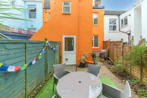 a patio with a table and chairs and a building at Charming 2 bed Flat with Secluded Garden in Brighton & Hove