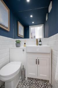 a bathroom with a white toilet and a sink at Beautiful Mews Cottage nr South Downs & Seaside in Rottingdean
