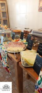 a table with a table with food on it at Pousada Parada Da Fé in Aparecida