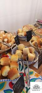 una mesa llena de diferentes tipos de pan y repostería en Pousada Parada Da Fé, en Aparecida