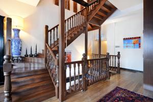 a wooden staircase in a home with wooden floors at Campbell House in George Town