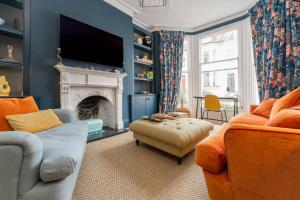 a living room with a couch and a fireplace at Contemporary & Colourful Flat + Garden in Brighton & Hove
