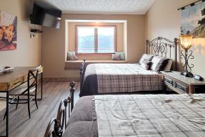 a bedroom with two beds and a table and a window at Sweet Mountain Delight #313 in Gatlinburg +23 photos
