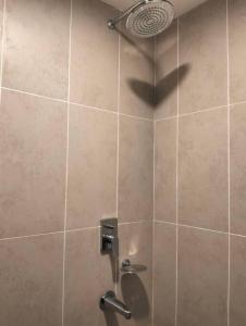 a bathroom with a shower with a shower head at MH Homestay 3R2B Condo very near to KLCC, Free Wi-Fi, Netflix & Parking in Kuala Lumpur