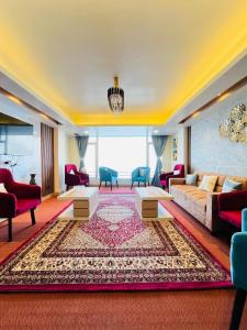 a living room with a couch and a rug at Luxury stay at Hotel Broadway Boutique Mall Road Chowrasta Near Mahakal Temple in Darjeeling