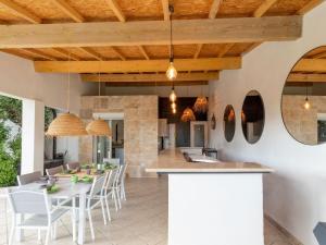 an open kitchen and dining room with a table and chairs at Magnificent villa with private pool in Narbonne