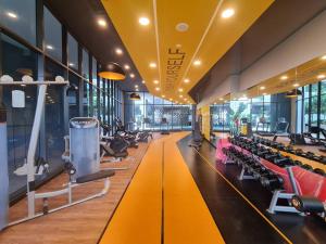 a gym with rows of treadmills and machines at Tiny Studio Suite Near Gleneagles 10 mins to KLCC in Kuala Lumpur