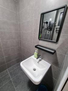 a bathroom with a sink and a mirror at Tiny Studio Suite Near Gleneagles 10 mins to KLCC in Kuala Lumpur +18 photos