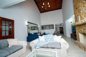 a living room with two couches and a fireplace at Casa Luna Azul in La Ceiba