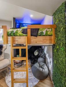 a bedroom with a bunk bed with a green wall at Dome House YYC, Iconic, Luxury, Backyard Oasis in Calgary