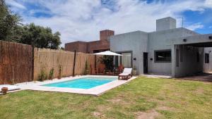 un patio trasero con piscina y una casa en Llevarte a vivir en San Rafael